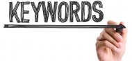 Hand with marker writing the word Keywords
